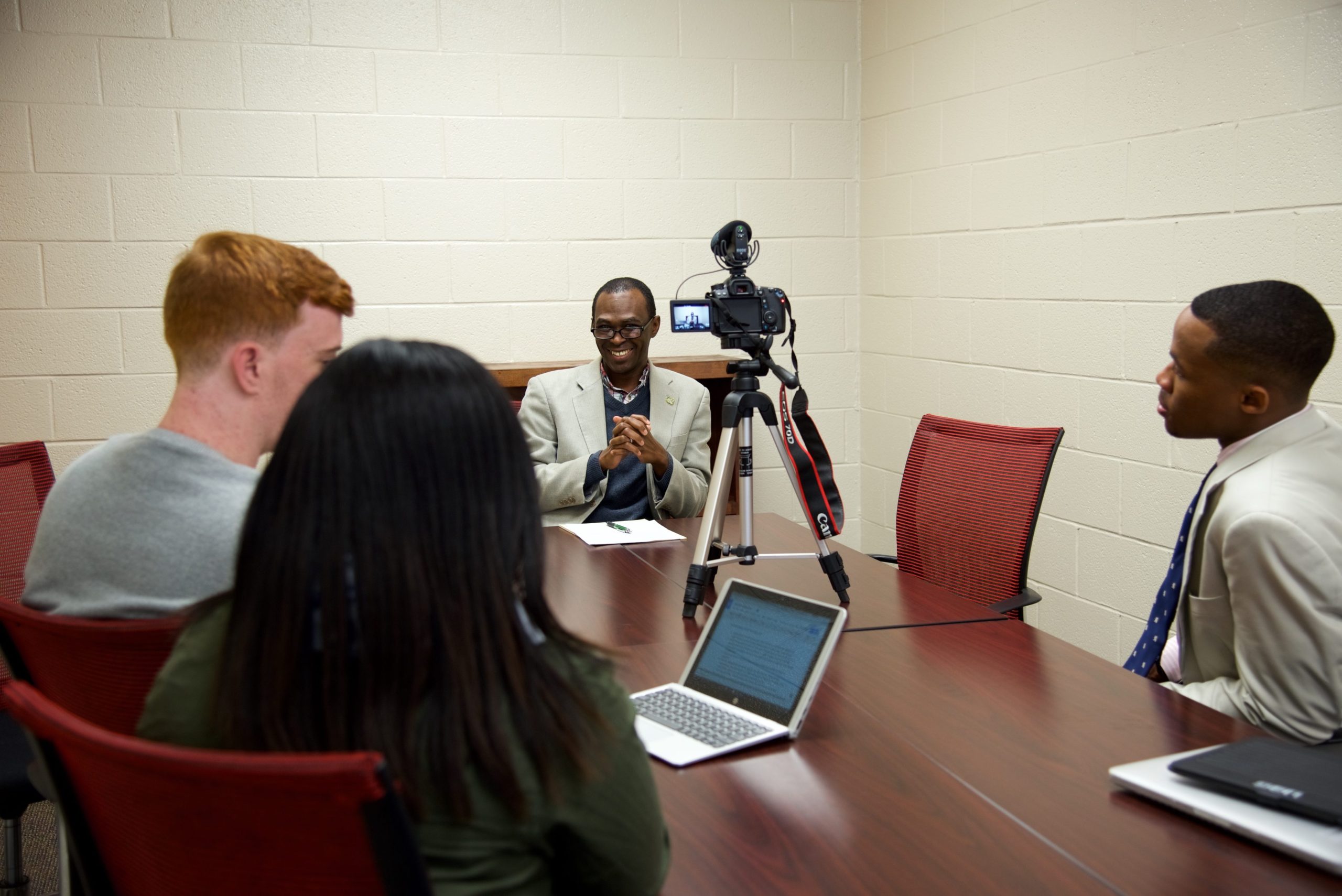 students with Akin Ogundiran filming him