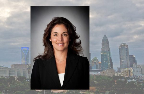 Dodson with city skyline behind her headshot