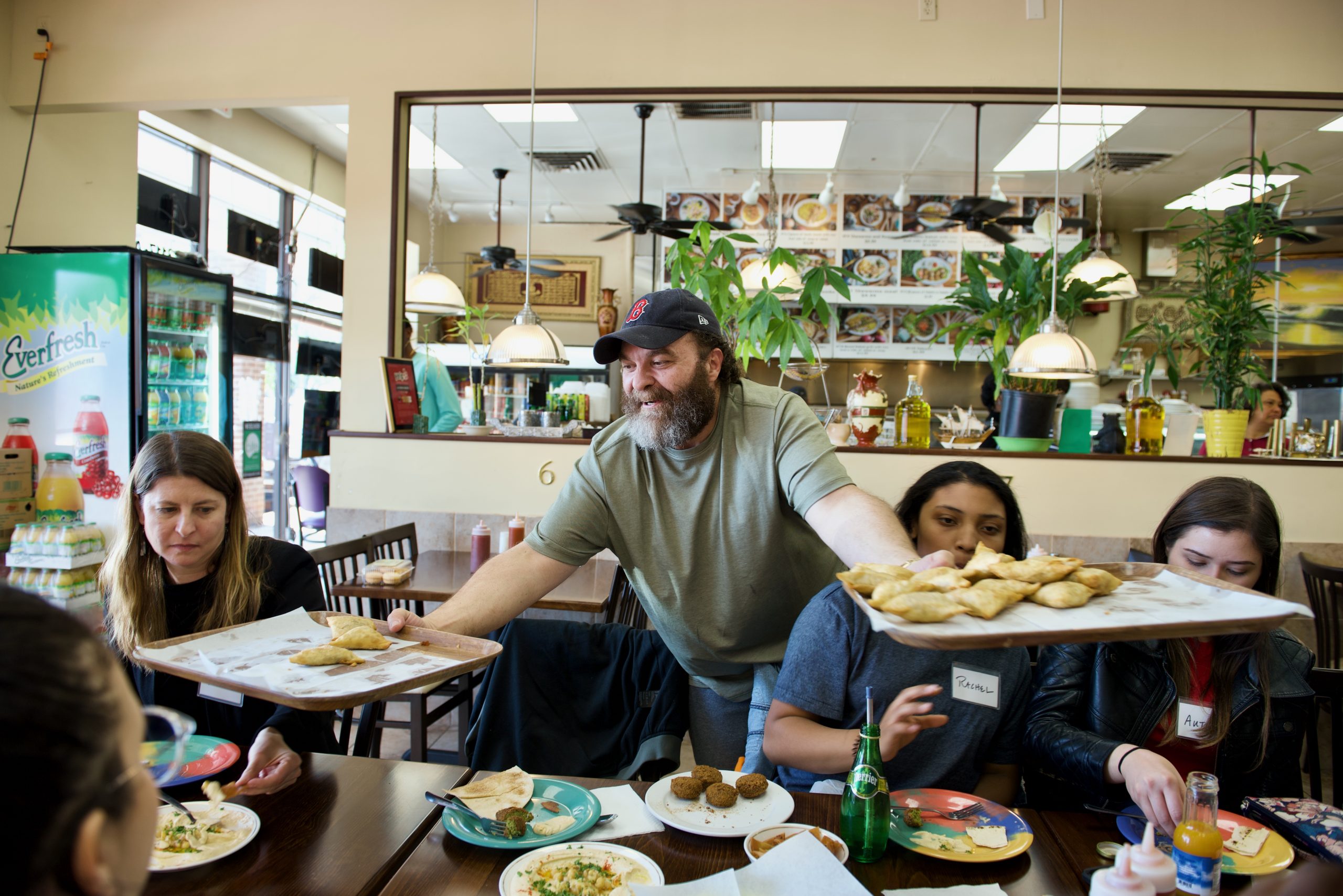 Izzat Freitekh, owner of La Shish Kabob, shares food with guests.