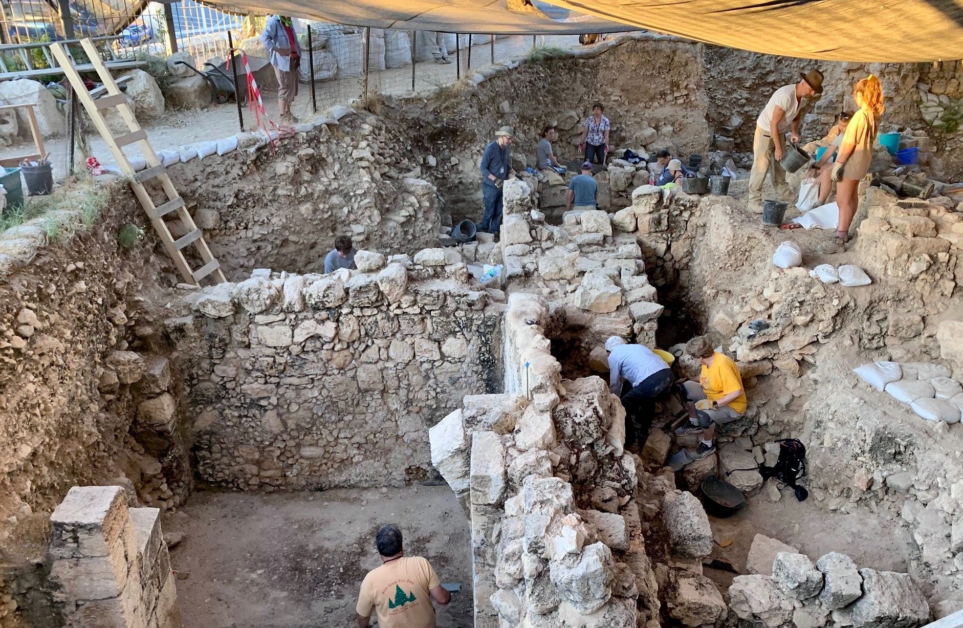 People working on the dig site, viewed from above.