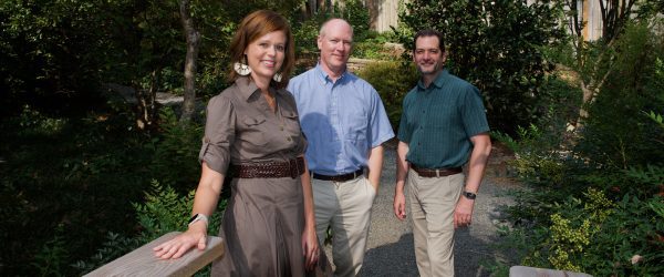 Stokes, Gillman and Michael standing at the end of a bridge near where the trail will be built.