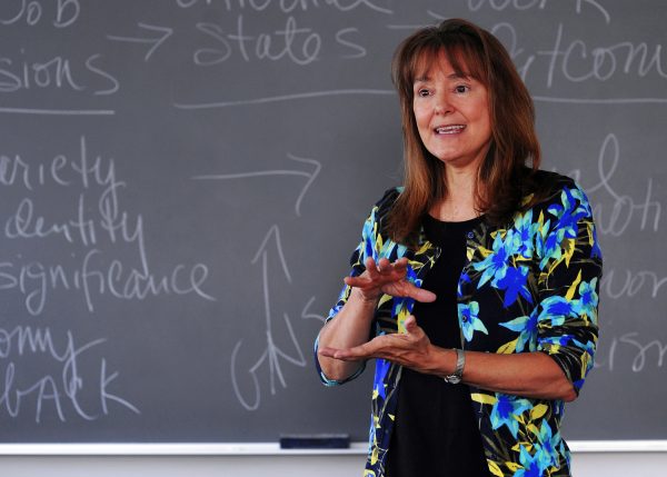 Kim Buch in front of a chalkboard