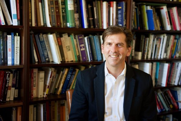 Mark Wilson in front of bookcase