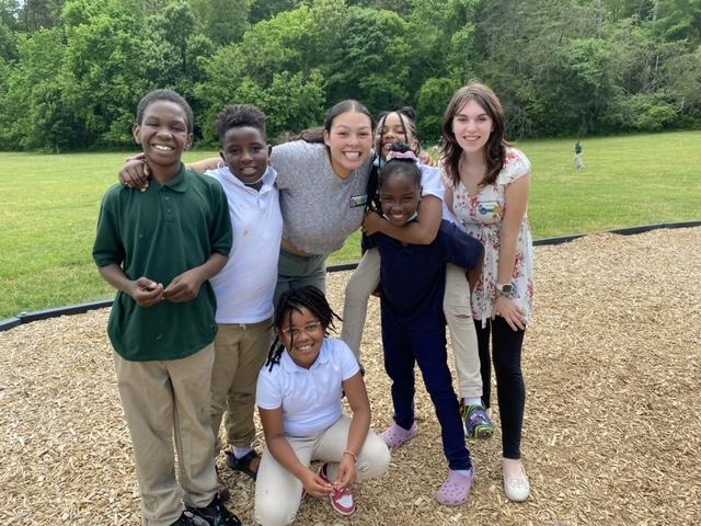 Niner University Elementary playground with teachers and students posing for a picture.